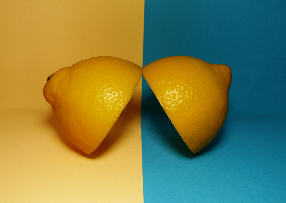 Two halves of a lemon on various backgrounds signal a duality