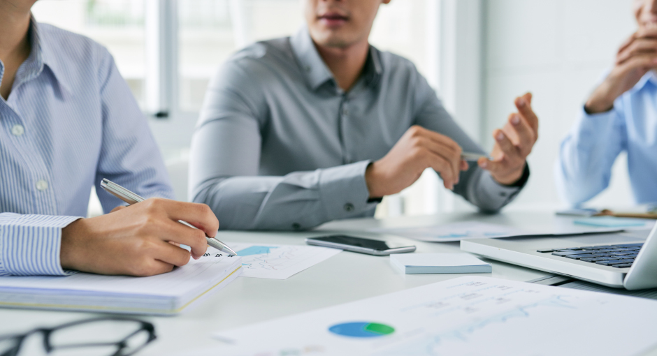 A team discusses business result charts