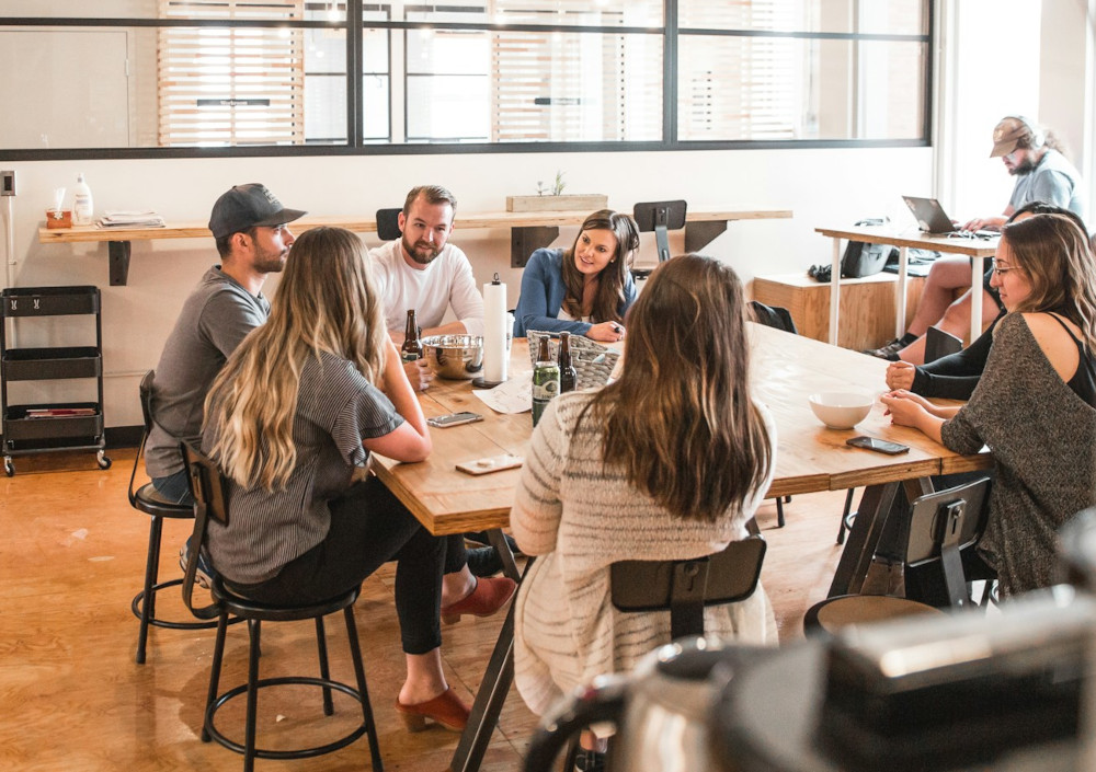 Team in lively discussion around a table 