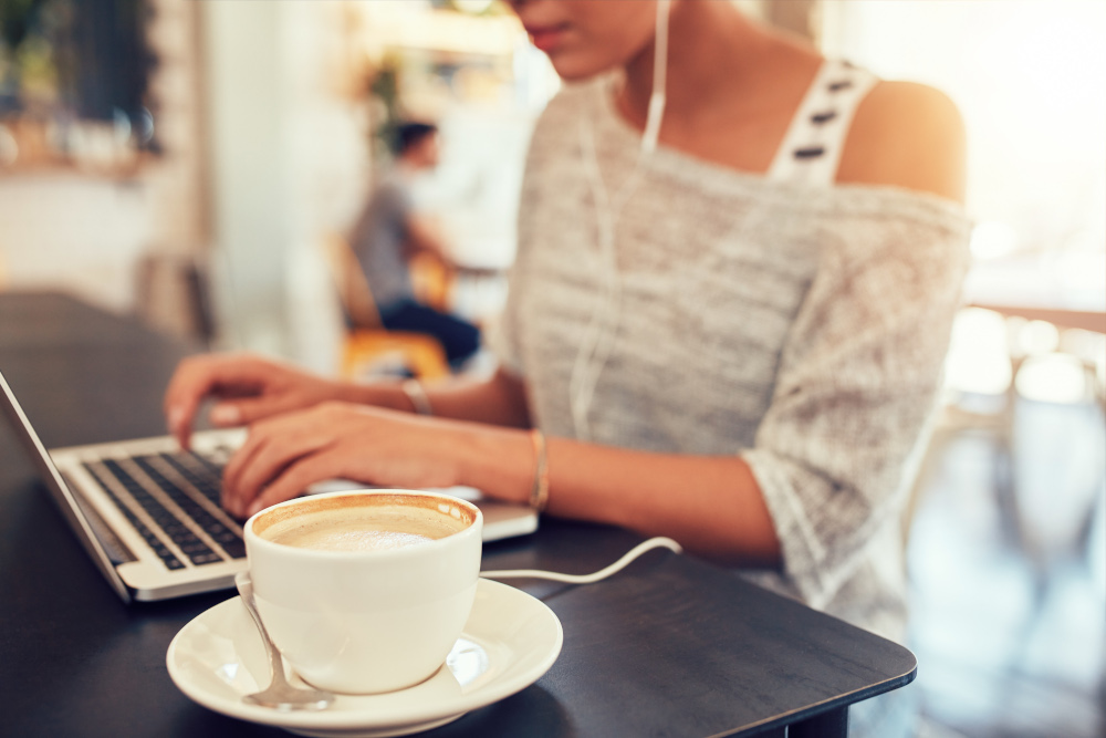Woman working on something personal during her coffee break