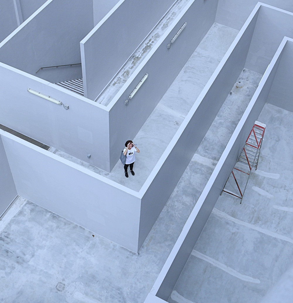 Woman standing inside a labyrinth deciding how to proceed