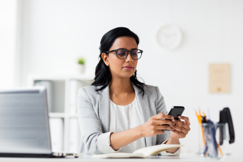 A woman calmly looking at her phone