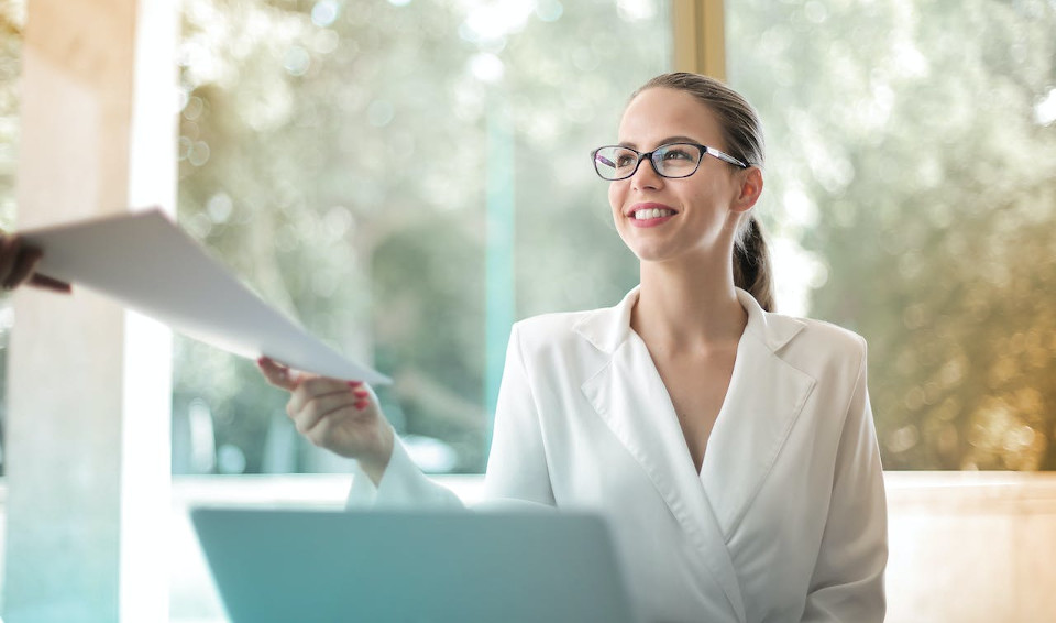 A woman is calmly handing over an assignment to someone else
