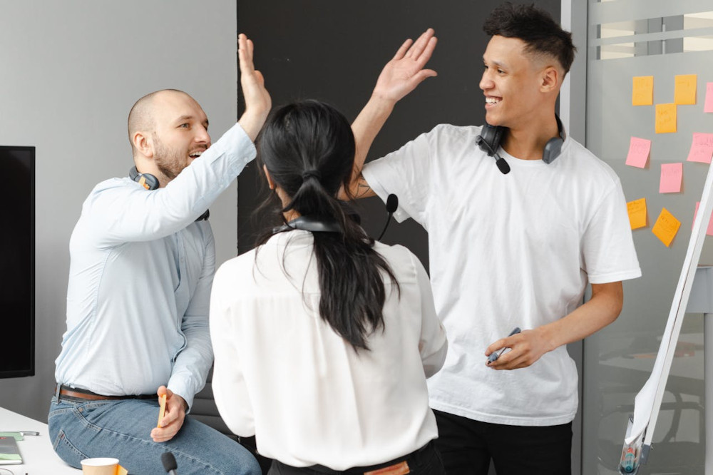 Colleagues high-fiving their shared success