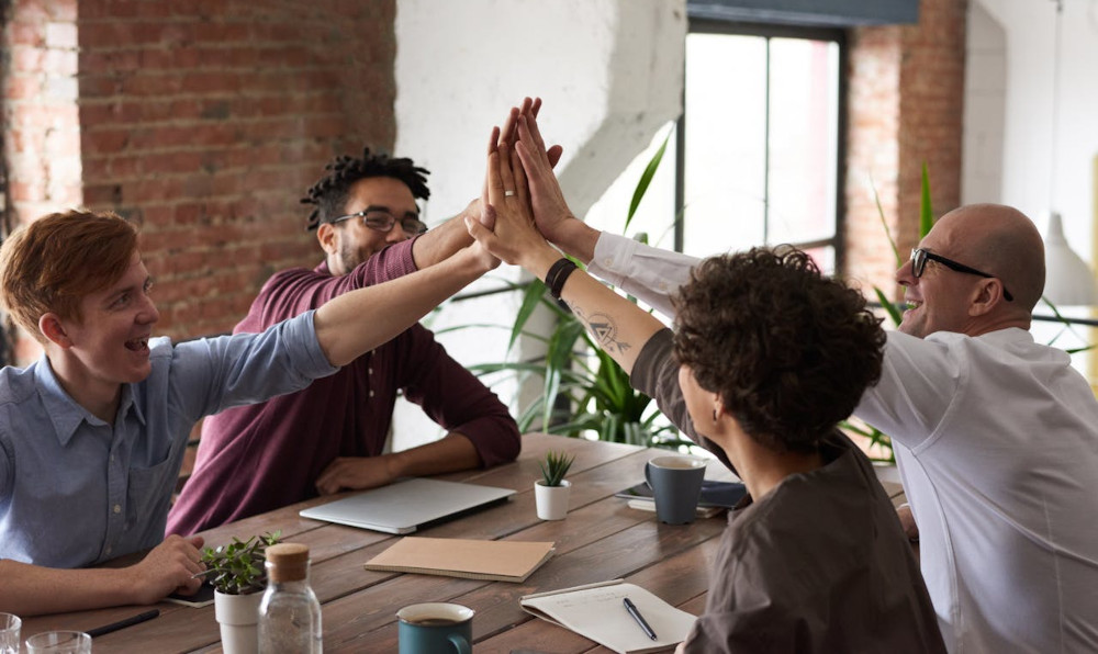 Team celebrating success at a conference table