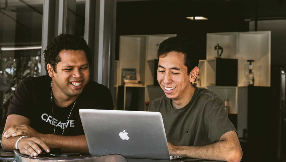 Colleagues deep in conversation in front of a laptop
