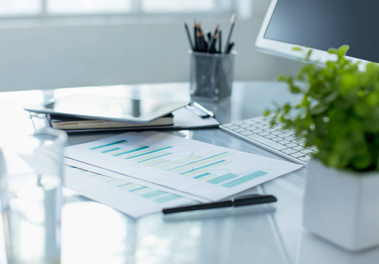 An office desk with performance metrics printed out to analyze