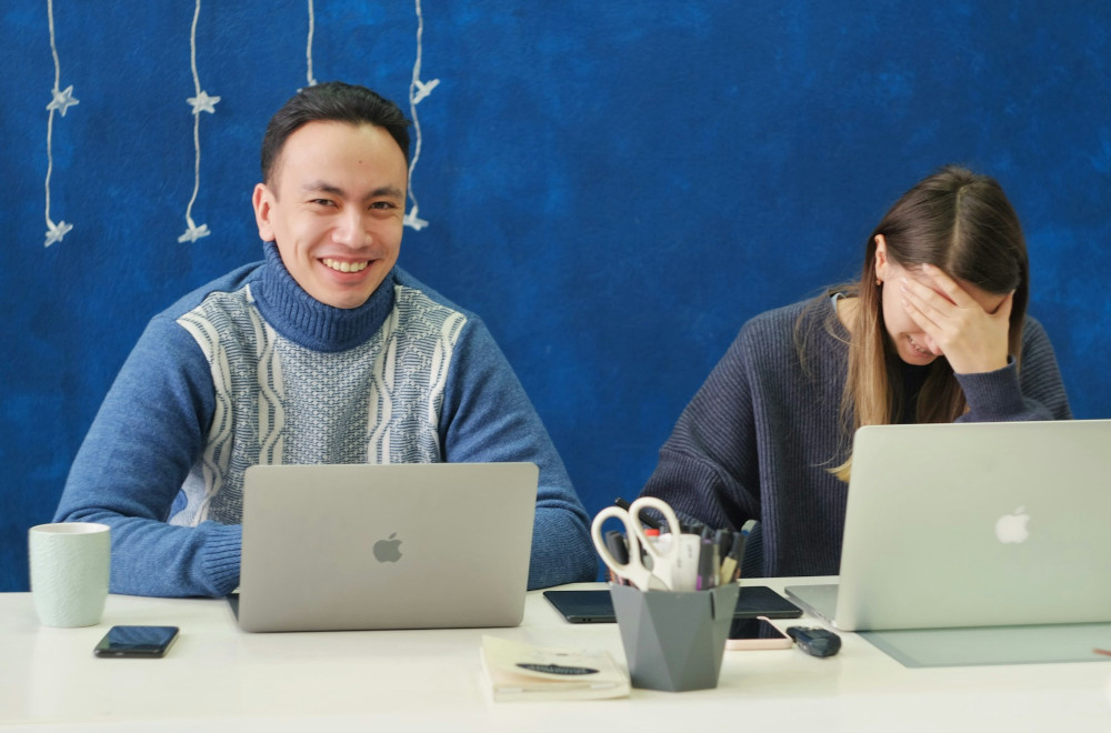 Relaxed colleagues laughing at the office