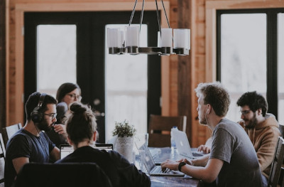 Colleagues in conversation at a shared office desk