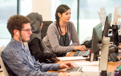 A team staying calm and collected in front of their computer screens