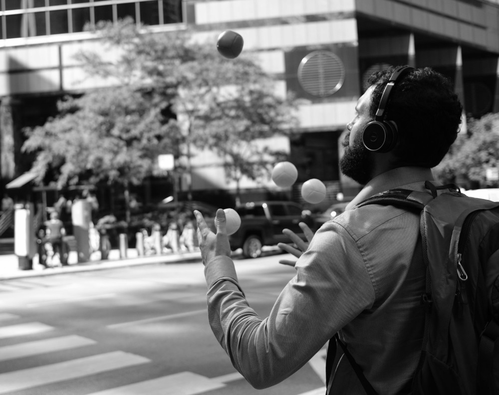 A man juggles balls in focus