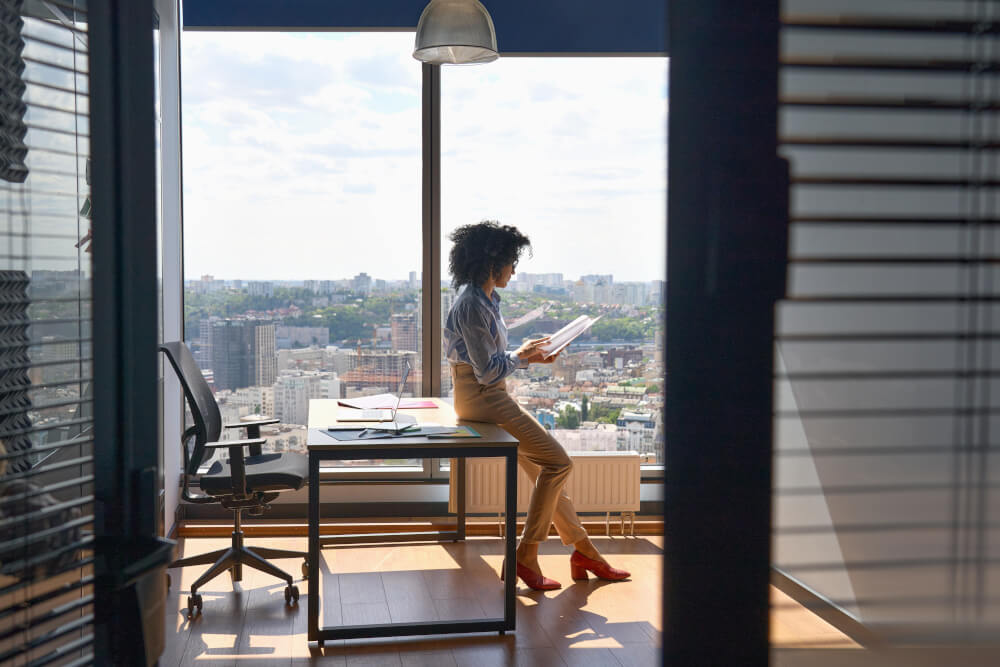 A woman is resting on her desk, taking a breather from her tasks
