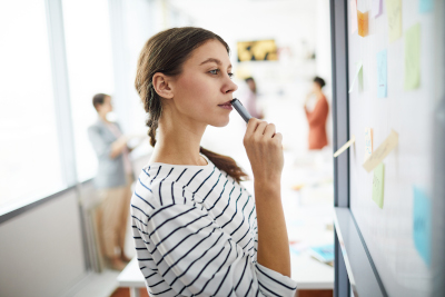 A woman working with an agile process board