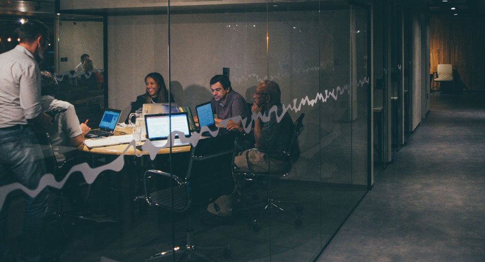Colleagues during a retrospective meeting in a conference room