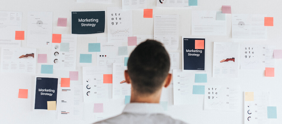 A man looking at a marketing strategy mind map